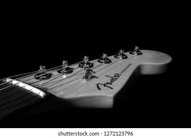 Brisbane, Queensland, Australia, January 2nd 2019. Fender Stratocaster guitar head stock against black background, Black and White.