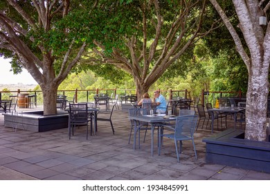 Brisbane, Queensland, Australia - March 2021: People Dining At A Winery Restaurant On Landscaped Outdoor Deck With Scenic Views