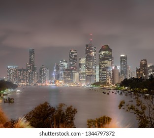Brisbane skyline by night. Beautiful view of the Brisbane city and river at night with building glowing after a stormy summer evening in Australia