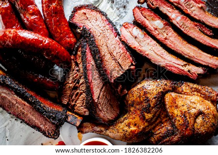 Brisket, pork ribs, beef ribs, chicken, pork sausage. Barbecue meat platter served with classic bbq sides Mac n cheese, cornbread, coleslaw & beer. Classic traditional Texas meats & side dishes.