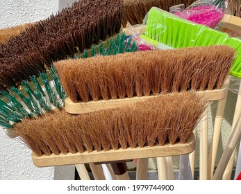 Bristles On The Heads Of Sweeping Brushes On Display Outside A Shop. No People.