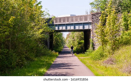 Bristol, England, UK - May 22, 2012: A cyclist rides through the green corridor of the Bristol and Bath Railway Path trail.