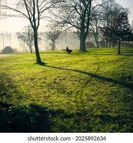 A Bristol park on a cold, bright, winter afternoon, fog rolling in through the nearby basin, the suspension bridge peeps above the clouds and an elderly man contemplates the view in the grassy, dew. - Powered by Shutterstock