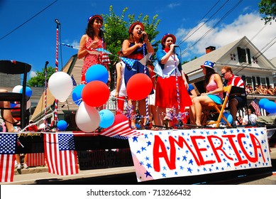 Bristol, RI, USA July 4 Three teenage girls sing patriotic tunes while traveling on a float during a Fourth of July parade in Bristol, Rhode Island.
