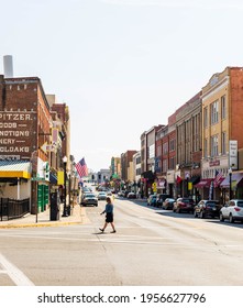 BRISTOL, TN-VA, USA-7 APRIL 2021: A View Of State Sreet From Piedmont Avenue, On A Sunny Day.  Woman Crosses The Street.