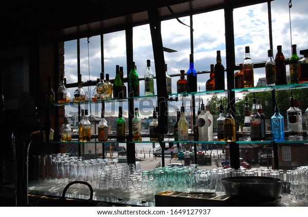 Bristol, UK - 7 29 2010: view out the bar window\
with bottles at Mud Dock\
Cafe