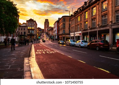 Bristol, UK. Famous street in the center of Bristol, UK in the evening during the colorful sunset. Bright cloudless sky at night. Various shops, cafes and restaurants.
