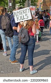 BRISTOL, UK - JULY 8, 2015: An Anti-austerity Demonstrator Holds A Placard With The Slogan “AUSTERITY KILLS”.