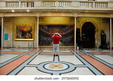 Bristol, UK – July 9, 2019 - Man Taking Picture Of An Art Piece Inside The Bristol City Museum And Art Gallery, England