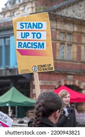 BRISTOL, UK - NOVEMBER 12, 2016: A Woman Carrying A Placard With The Slogan “STAND UP TO RACISM” 