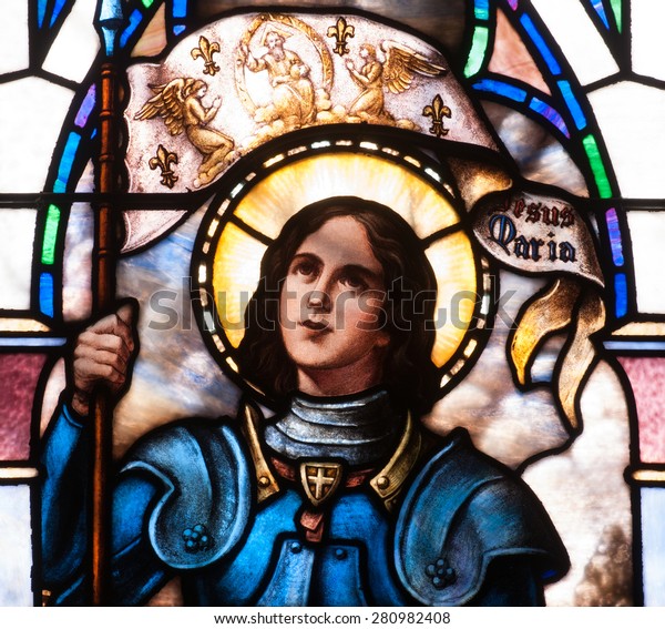BRISTOW, VIRGINIA - APRIL 26, 2015: Stained glass window of close up of St. Joan of Arc, located in chapel of St. Benedict Monastery
