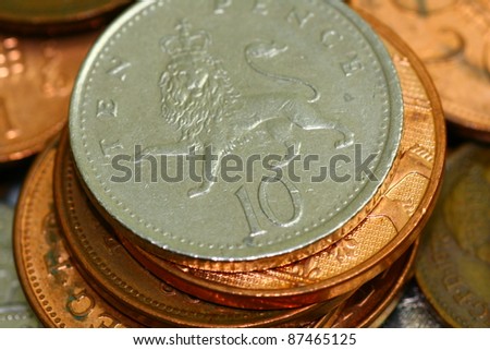 British 10 pence on a pile of coins