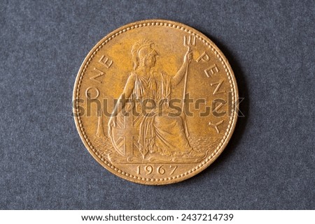 A British 1967 One Penny coin. Pre-decimal copper coin.