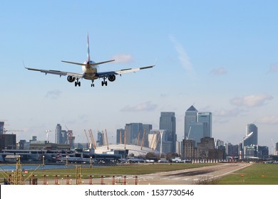 British Airways Plane Landing At London's City Airport On A Sunny Day With Canary Wharf In The Background. London -  16th February 2016