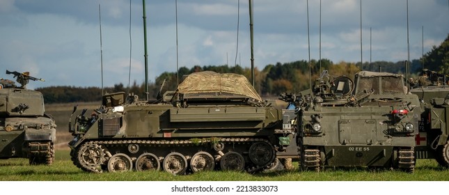 British Army Challenger II 2 FV4034 Battle Tanks With Bulldog FV432 APCs In Open Countryside On A Military Exercise Wiltshire UK