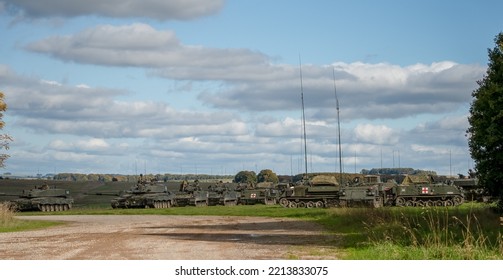 British Army Challenger II 2 FV4034 Battle Tanks, Bulldog FV432 APCs And Warrior FV510s In Open Countryside On A Military Exercise Wiltshire UK