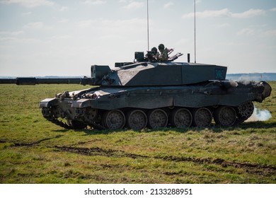 British Army FV4034 Challenger 2 Main Battle Tank Throws Out A Cloud Of Diesel Smoke In Action On A Military Exercise