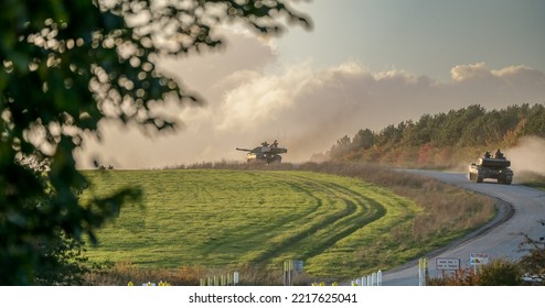 British Army FV4034 Challenger 2 Ii Main Battle Tanks Descend A Country Track To A Road Crossing, Wiltshire UK