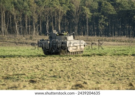 British army General Dynamics Ajax tank, reconnaissance and strike, armoured fighting vehicle (AFV) in action in countryside. Wiltshire UK