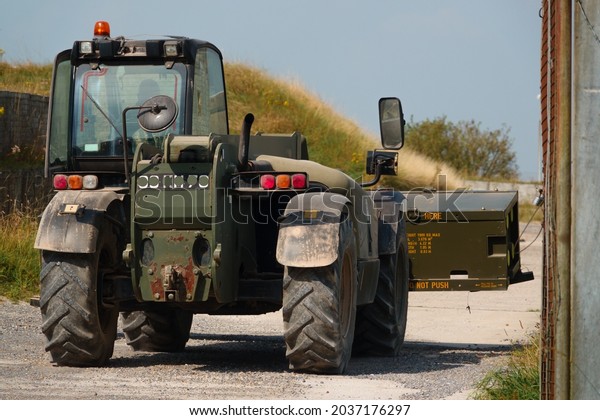 British army JCB\
fork lift truck moving boxed weapons in preparation for next\
military exercise, Wiltshire\
UK
