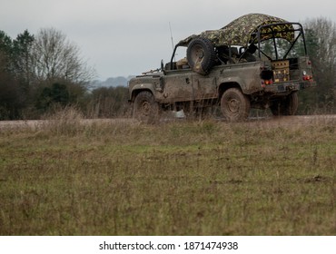 British Army Land Rover Defender 110 Wolf 4x4 In Action On A Military Exercise, Salisbury Plain UK