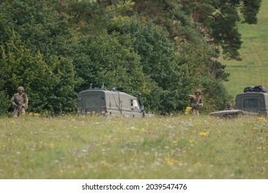 British army Land Rover Defender Wolf truck utility medium military vehicle with infantry soldiers on exercise, Salisbury Plain UK