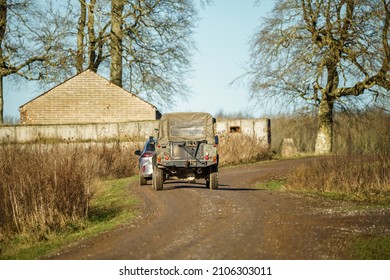 British Army Land Rover Defender 110 Wolf 4x4 Follows A Road Car In Action On A Military Exercise, Salisbury Plain UK