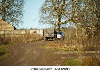 British Army Land Rover Defender 110 Wolf 4x4 Follows A Road Car In Action On A Military Exercise, Salisbury Plain UK