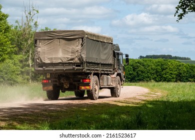 British Army MAN SV 4x4 Logistics Truck Driving Away From Camera On A Military Exercise