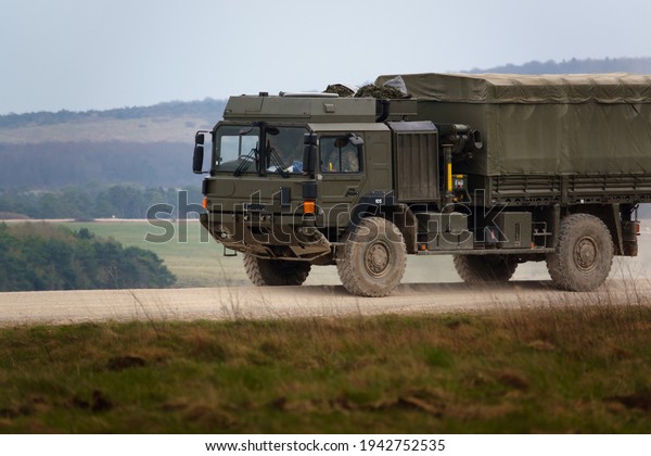 British army MAN SV 4x4 army logistics lorry vehicle\
truck driving along a dirt track in action on a military exercise,\
Salisbury Plain UK