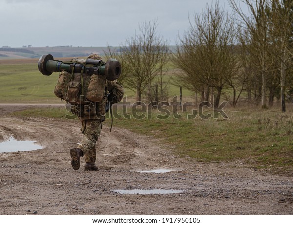 British army soldier completing
an 8 mile combat fitness test tabbing exercise with fully loaded
25Kg bergen and NLAW (MBT-LAW, RB-57) anti-tank guided
missile