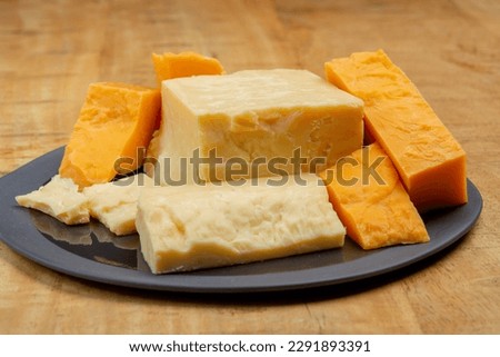 British cheeses collection, Scottish coloured and English matured cheddar cheeses close up