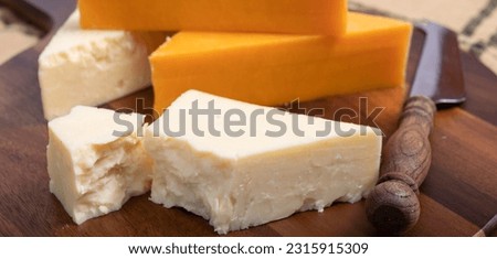 British cheeses collection, Scottish coloured and English matured cheddar cheeses close up.