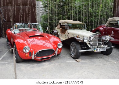 British Classic AC Shelby Cobra vintage muscle car, Roadster car and Mercedes - Gazelle from 1929 retro car . Collection cars on display in the park. Kharkov, Ukraine - July 3, 2021
