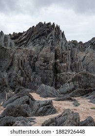 British Coastal Jagged Rock Formations with Sandy Beach