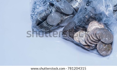 British coins in bank coing collecting plastic bags on a white background.