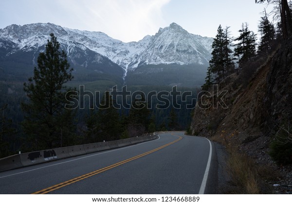 British Columbia Canada sea to sky highway\
road with snowy mountain in\
background
