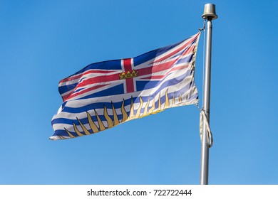 British Columbia Flag Waving Over Blue Sky In Vancouver, BC, Canada