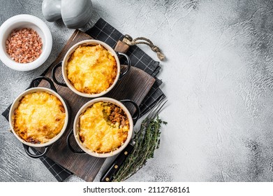 British dish Shepherd's pie with ground meat, mashed potato and cheddar cheese crust. White background. Top view. Copy space