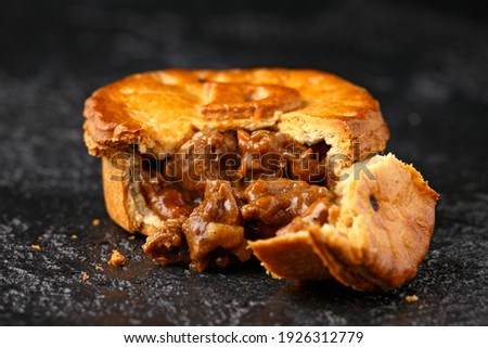 British duck pie on rustic dark background