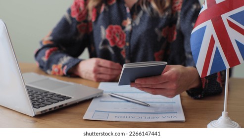 British embassy woman officer giving passport to man immigrant, student visa approval, work visa, citizenship. Visa Application online form immigration concept. Visa approval. - Shutterstock ID 2266147441