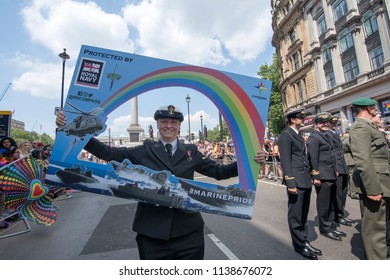 British Female Military Officer  Participates In The Gay Pride Parade, Adorned With Rainbow And Other Placard  LGBT+ Flags. London UK 07/04/ 2018