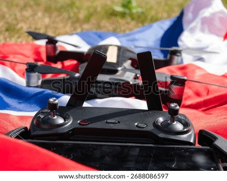 British Flag and hands with drone and remote controller in background close up shot selective focus