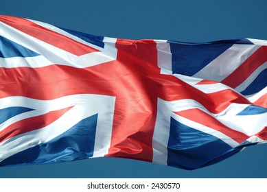 British Flag Waving To The Wind Against The Sky