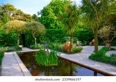 British Gardens with the pond. The British Lost Gardens of Heligan Pentewan Cornwall. Ornamental garden pond UK.
