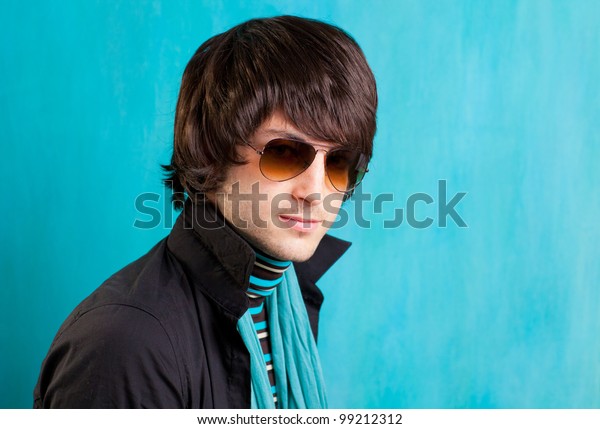 british indie pop rock look retro hip young man with\
sunglasses on blue