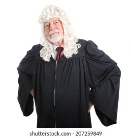 British Judge In Wig With Hands On Hips In A Stern Posture.  Isolated On White.