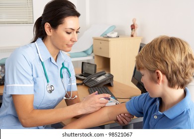 British Nurse Giving Injection To Child