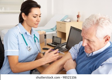 British Nurse Giving Injection To Senior Man