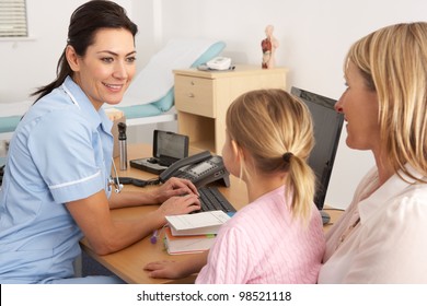 British Nurse Talking To Young Child And Mother